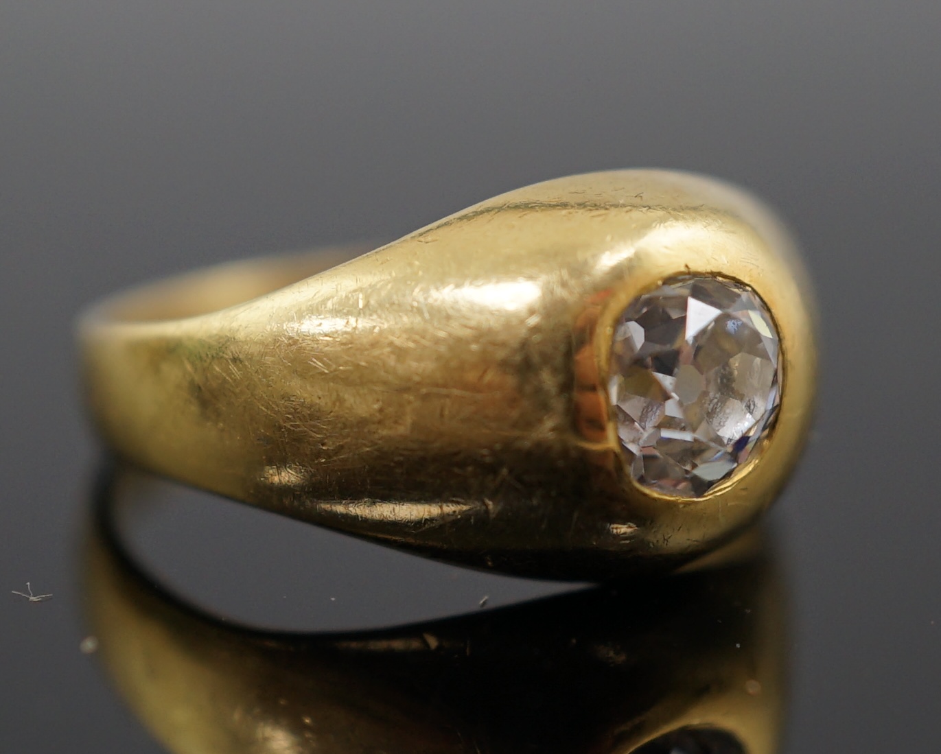 A gold and gypsy set old round cut diamond ring